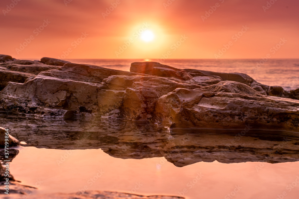tidepool at sunset with reflection