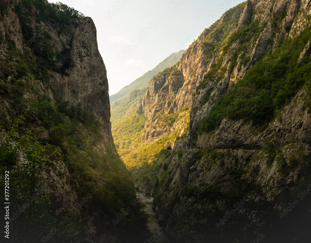 Impressive gorge with a river between two large mountains, sunrise in montenegro and a journey through the nature of europe