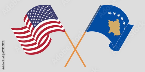 Crossed and waving flags of Kosovo and the USA