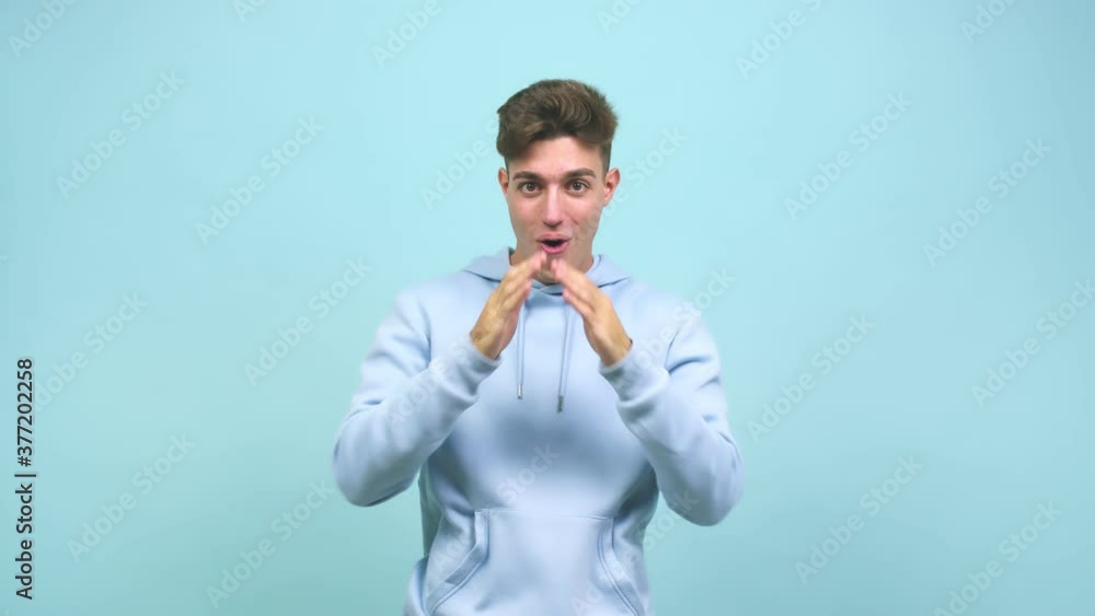 Young caucasian student man surprised and shocked, looking with wide eyes, excited by an offer or by a new job