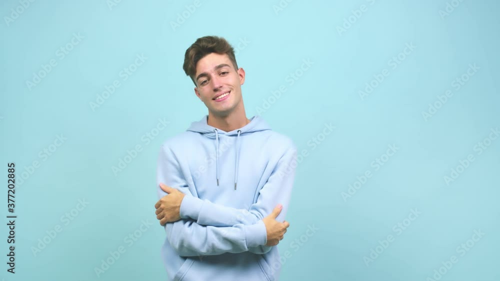 Young caucasian student man crossing his arms, serious and imposing, feeling confident and proud Young caucasian student man crossing his arms, serious and imposing, feeling confident and proud