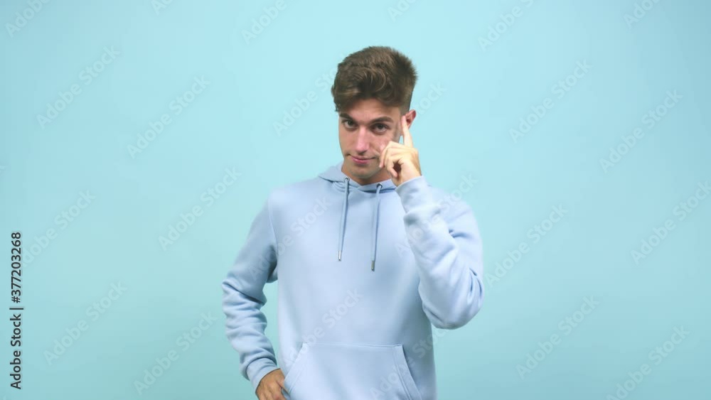 Young caucasian student man showing number one, symbol of counting, concept of mathematics, confident and cheerful Young caucasian student man showing number one, symbol of counting, concept of mathematics, confident and cheerful