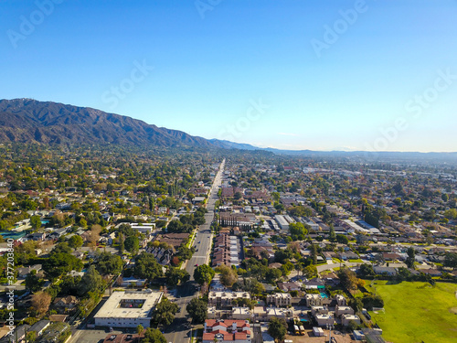 stunning aerial shot of the snow capped mountain ranges and blue skies of Monrovia California with a view of the homes below photo
