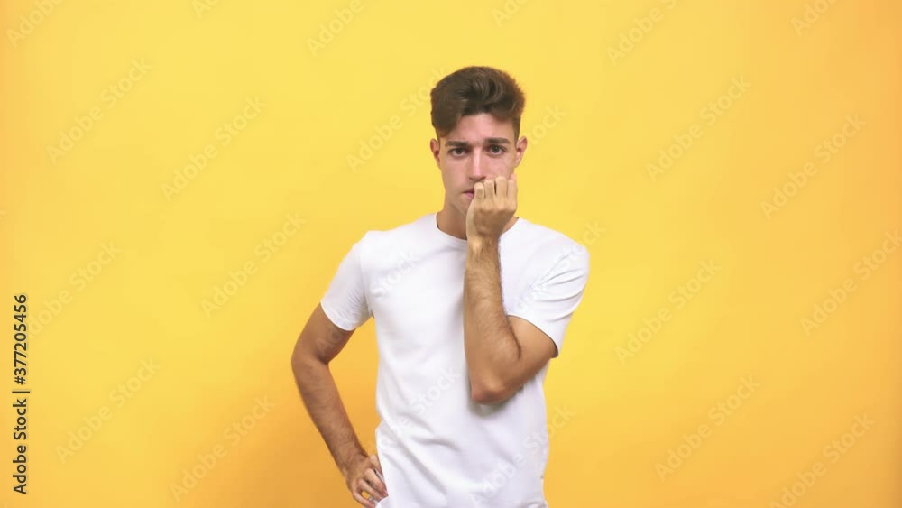 Young caucasian student man biting nails, nervous and very anxious and scared for the future, feels panic and stress Young caucasian student man biting nails, nervous and very anxious and scared for the future, feels panic and stress