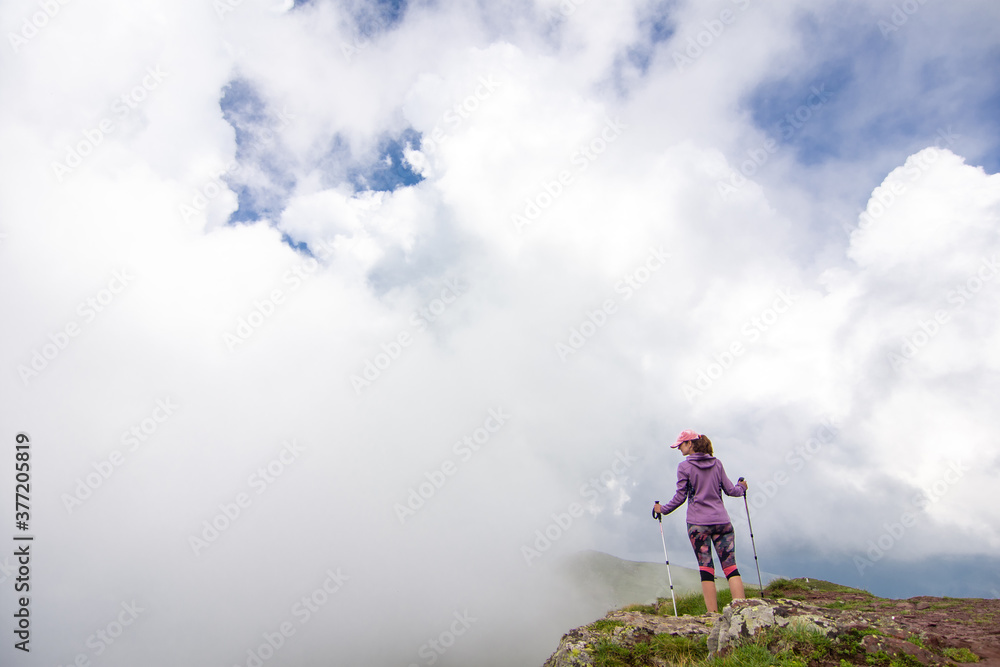  Woman walking in the mountains. Young woman with backpack hiking in the mountains. Stara planina (Old mountain) in eastern Serbia