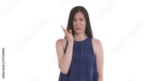 Caucasian woman sniffing air around her, feeling stench and waving hand in front of face with displeased facial expression. Isolated on white background