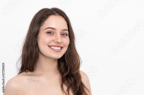 Woman with blue eyes and long hair smiling and looking at the camera. On a white background  isolate.