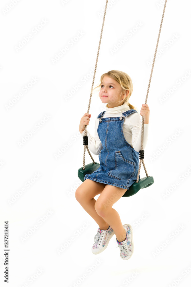 Full Length Shot of Cute Happy Girl Sitting on Rope Swing