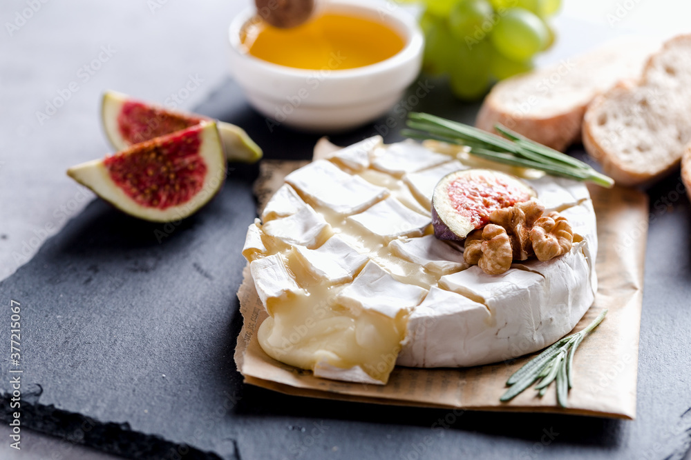 Oven baked Camembert with honey, nuts, figs and rosemary, gastronomic delight