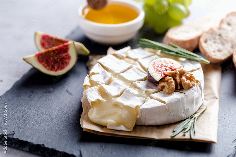 Oven baked Camembert with honey, nuts, figs and rosemary, gastronomic delight Oven baked Camembert with honey, nuts, figs and rosemary, gastronomic delight