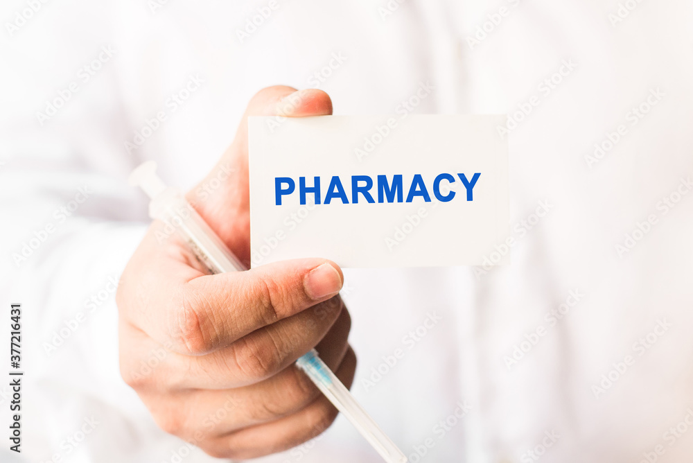 Word pharmacy on a white background with a syringe in hand. Preventive Medicine Word pharmacy on a white background with a syringe in hand. Preventive Medicine
