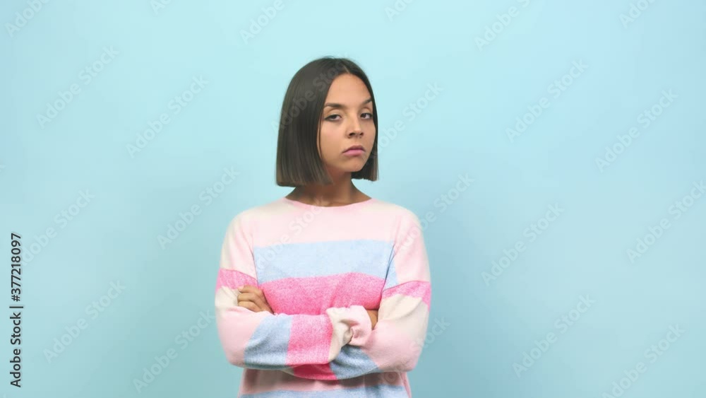 Young indian woman looking straight ahead, serious face, arms crossed, concept of goal and a purpose Young indian woman looking straight ahead, serious face, arms crossed, concept of goal and a purpose