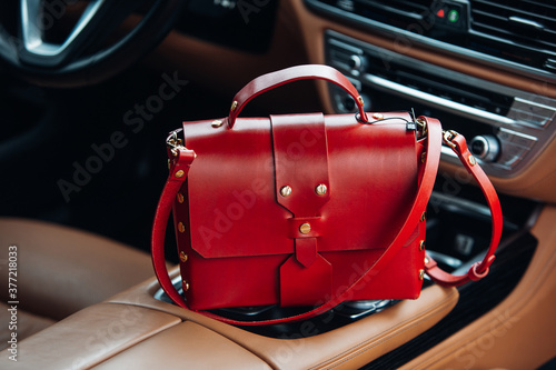 Women's handbag in the interior of a luxury car