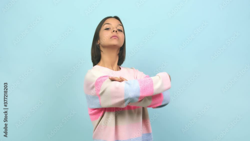 Young indian woman looking straight ahead, serious face, arms crossed, concept of goal and a purpose Young indian woman looking straight ahead, serious face, arms crossed, concept of goal and a purpose