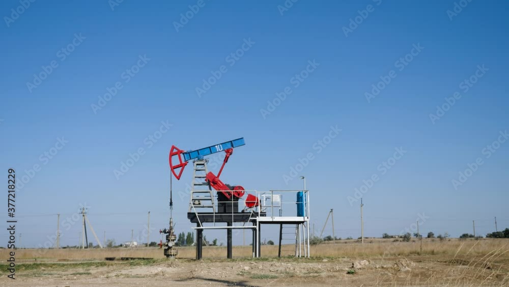 oil rig stands in a field and extracts minerals from the ground oil rig stands in a field and extracts minerals from the ground