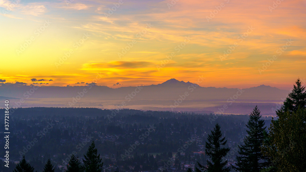 Fototapeta premium dawn breaking over mount baker as seen from a Burnaby Mountain residence