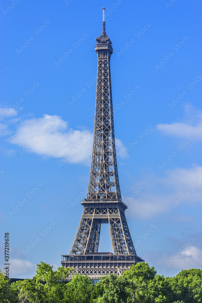 Tour Eiffel (Eiffel Tower) located on Champ de Mars, named after engineer Gustave Eiffel. Eiffel Tower is tallest structure in Paris and most visited monument in world. Paris, France.