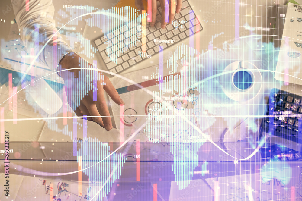 Double exposure of man's hands typing over computer keyboard and business theme hologram drawing. Top view. Financial markets concept. Double exposure of man's hands typing over computer keyboard and business theme hologram drawing. Top view. Financial markets concept.