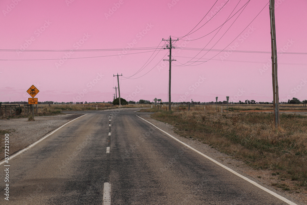 Fototapeta premium a deserted country road intersection at dawn