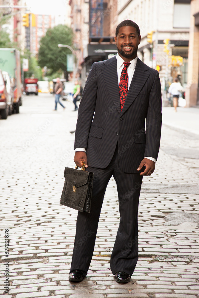 Black businessman smiling on city street Black businessman smiling on city street