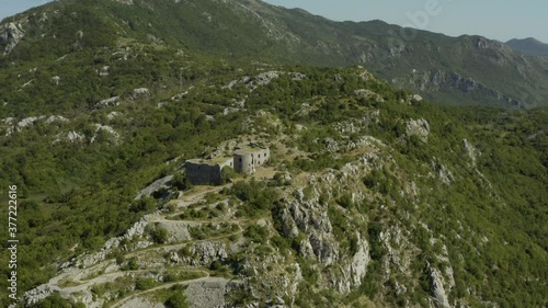 Aerial view of medieval fortress Fort Kosmac in Montenegro. Drone shot ruin of an old stone fortress on the top of the hill. photo