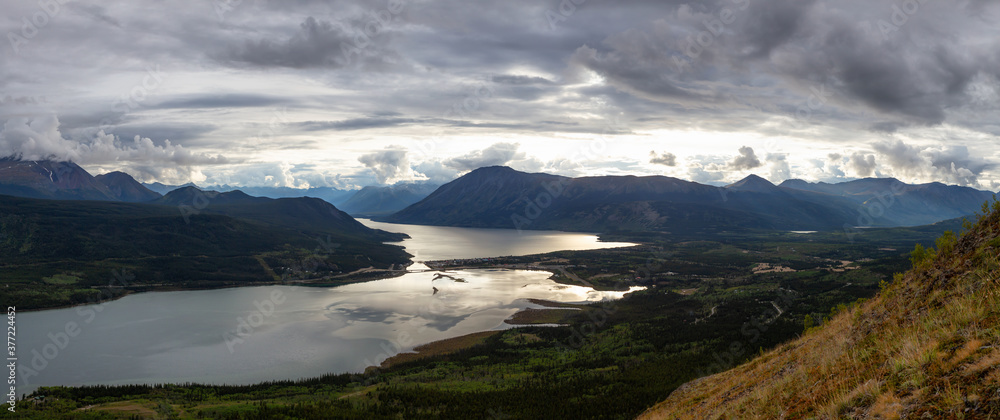 Beautiful Panoramic View of a small Touristic Town, Carcross, surounded by Canadian Mountain Landscape. Located near Whitehorse, Yukon, Canada.