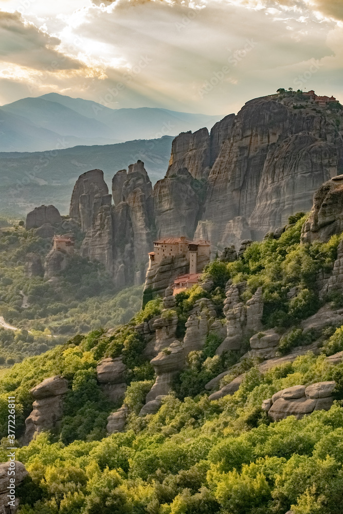 Vertical image of Meteora rocks with Monastery in the morning mist