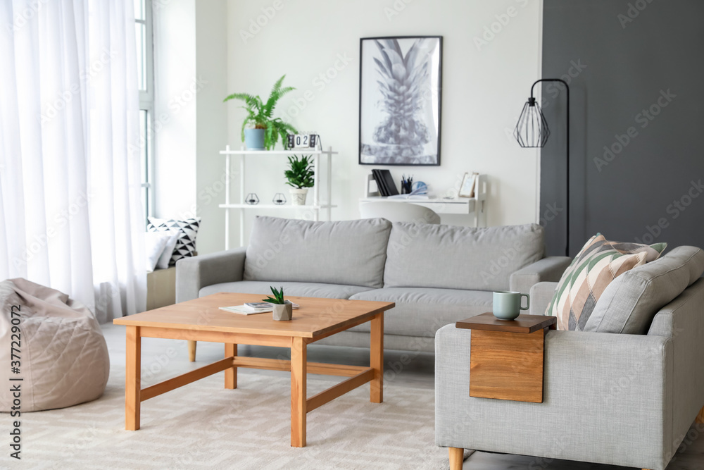 Armrest table on sofa in interior of room Armrest table on sofa in interior of room