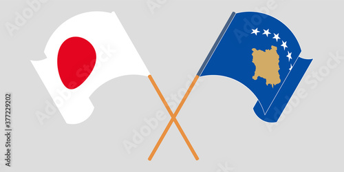 Crossed and waving flags of Kosovo and Japan