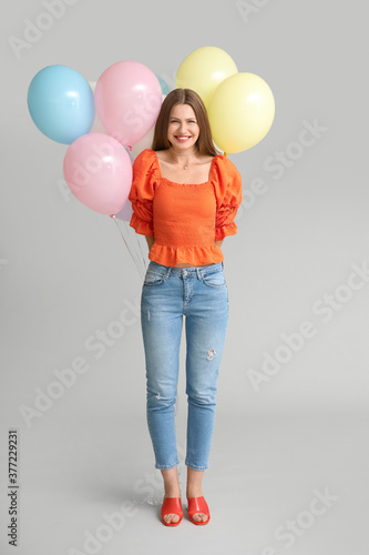 Young woman with balloons o...