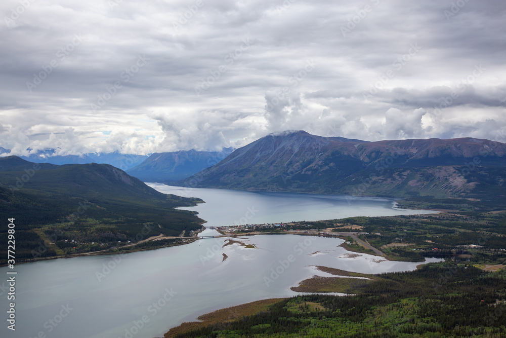 Naklejka premium Beautiful View of a small Touristic Town, Carcross, surounded by Canadian Mountain Landscape. Located near Whitehorse, Yukon, Canada.