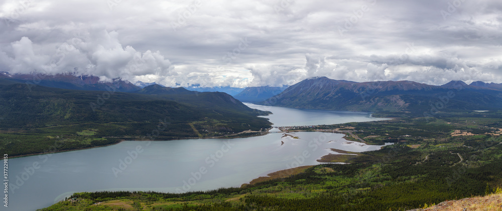 Beautiful Panoramic View of a small Touristic Town, Carcross, surounded by Canadian Mountain Landscape. Located near Whitehorse, Yukon, Canada.