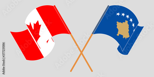 Crossed and waving flags of Kosovo and Canada