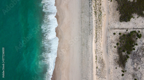 Aerial view of beach waves crashing on the shore