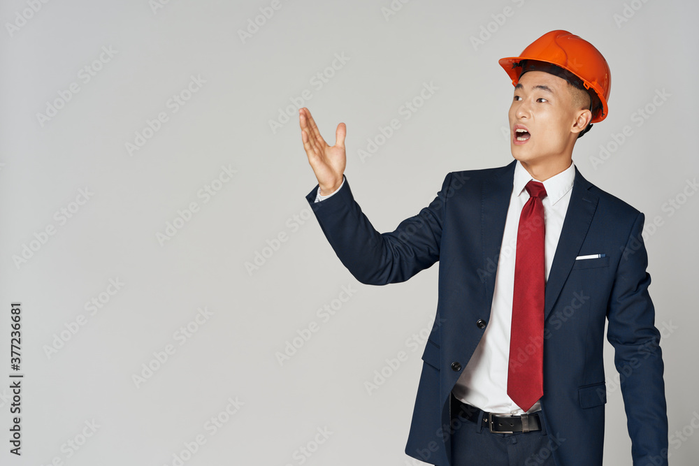 handsome man in a classic suit and with a helmet on his head architect handsome man in a classic suit and with a helmet on his head architect