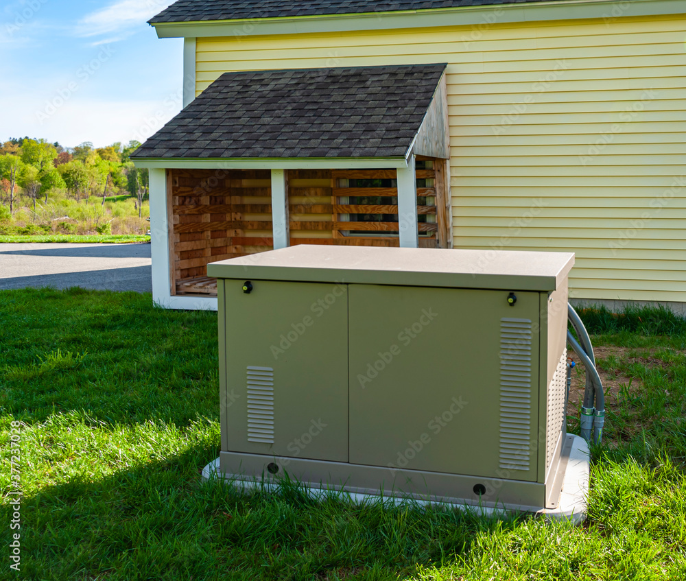 Residential standby generator at the house wall - obrazy, fototapety, plakaty 