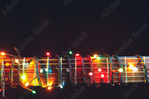 guitar finger-board with multicolor lights, festive background