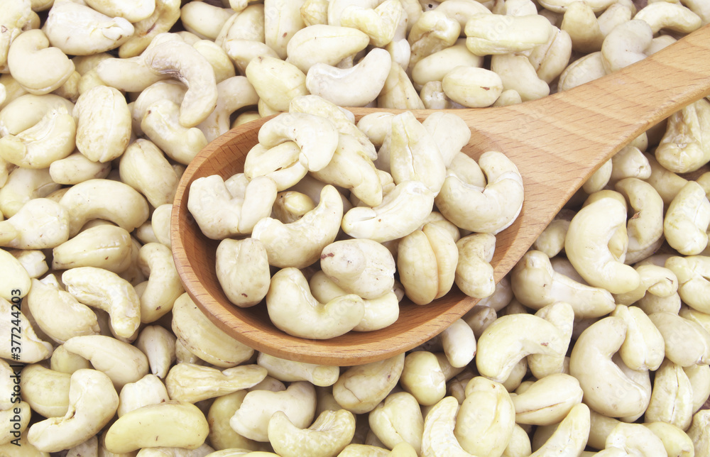 Cashew nuts with wooden spoon