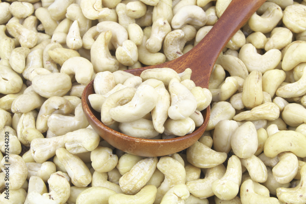 Cashew nuts with wooden spoon Cashew nuts with wooden spoon