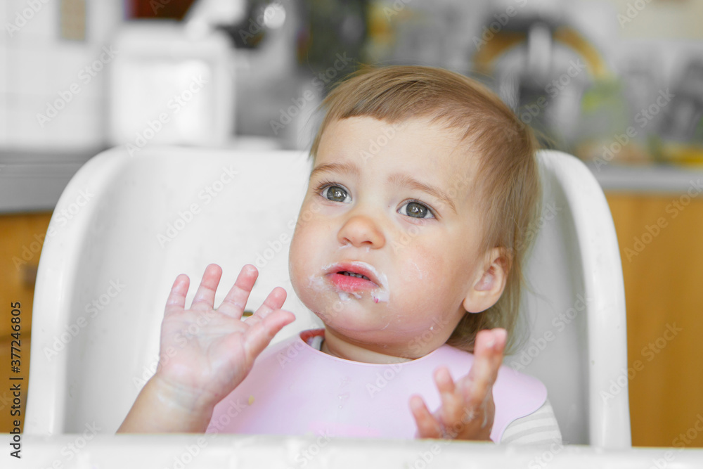 portrait of a child who smeared face with food portrait of a child who smeared face with food