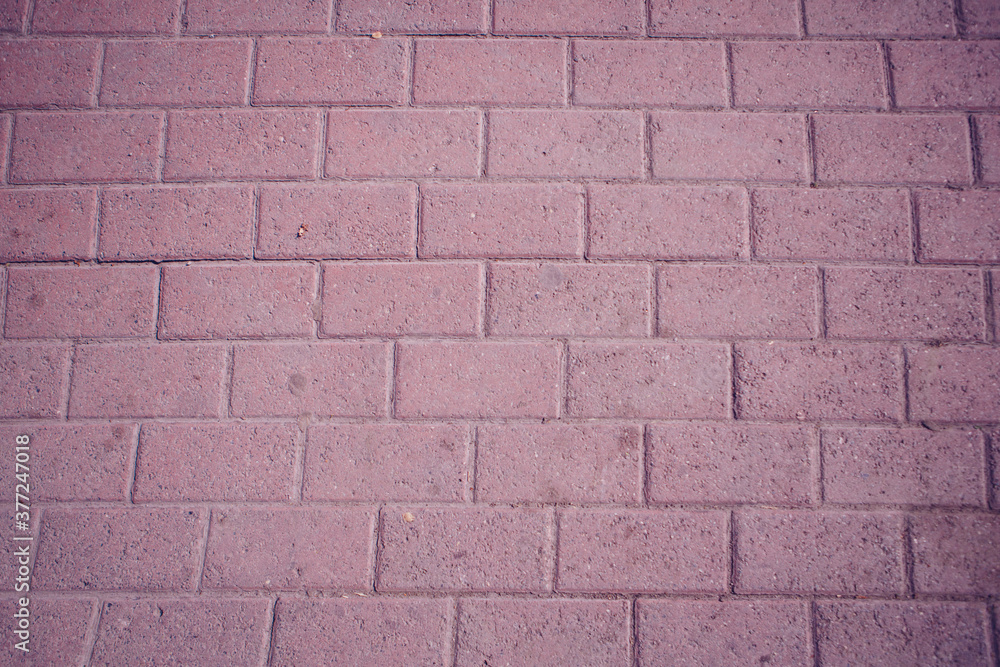 Naklejka premium Textured: pink asphalt brick close - up as background