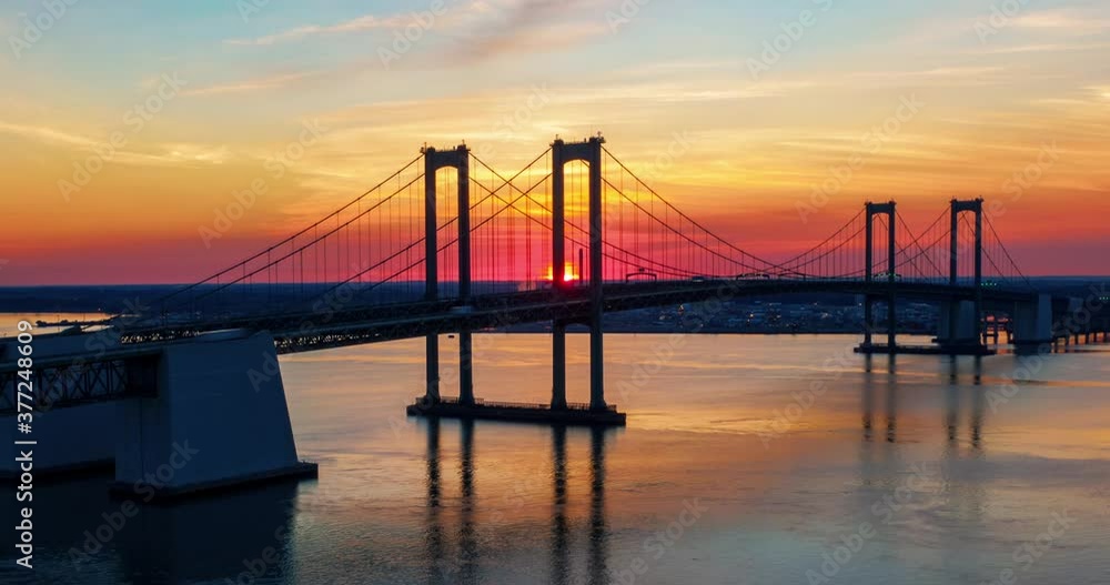 Delaware Memorial Bridge, two suspension spans, Delaware River to New Jersey, civil architecture and engineering marvel, hyperlapse timelapse at beautiful sunrise sunset, traffic on interstate Delaware Memorial Bridge, two suspension spans, Delaware River to New Jersey, civil architecture and engineering marvel, hyperlapse timelapse at beautiful sunrise sunset, traffic on interstate