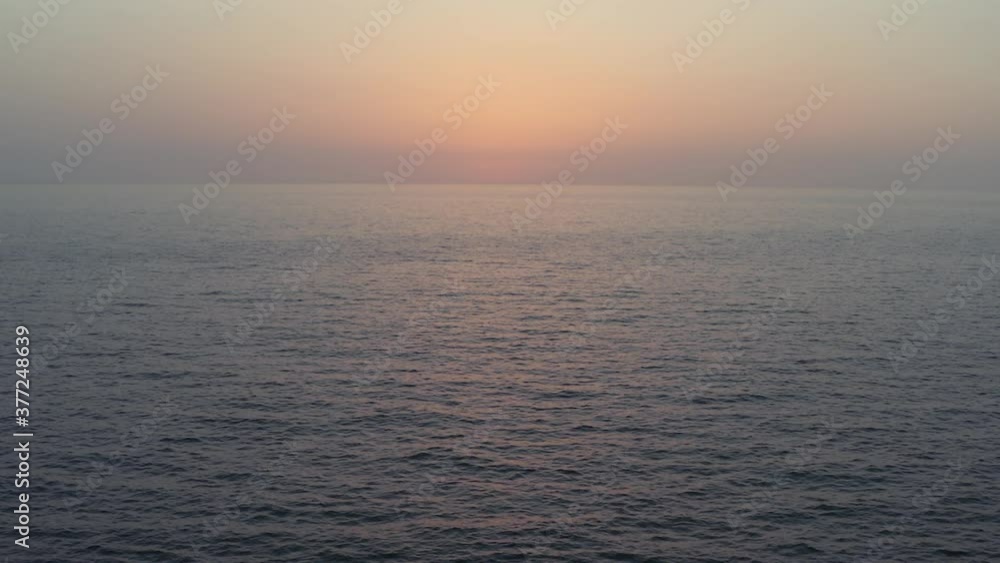 aerial plane of drone with sea at sunset with sun and sunlight traveling in beautiful colors with waves and incredible sea tide aerial plane of drone with sea at sunset with sun and sunlight traveling in beautiful colors with waves and incredible sea tide