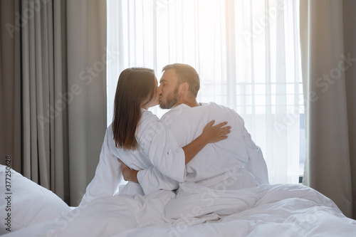 Young cute couple, man and woman in bed.