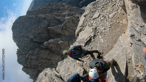 Olymp, Greece - 22 Jul, 2018: Mountaineer pov to expedition climbing to Mytikas rocky summit on Olympos mountain in Greece, vertical orientation photo