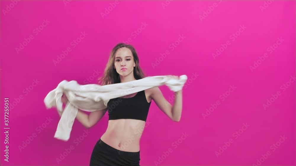 Young Teenage Girl with Long Hair Dancing and Having Fun on Pink Background. Celebrating joy and happiness. Success, party, holiday concept Young woman Shaking Hair While Listening to Music Young Teenage Girl with Long Hair Dancing and Having Fun on Pink Background. Celebrating joy and happiness. Success, party, holiday concept Young woman Shaking Hair While Listening to Music