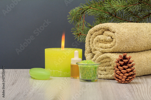 Spa composition with towel, aromatic oil, soap, sea salt and candle