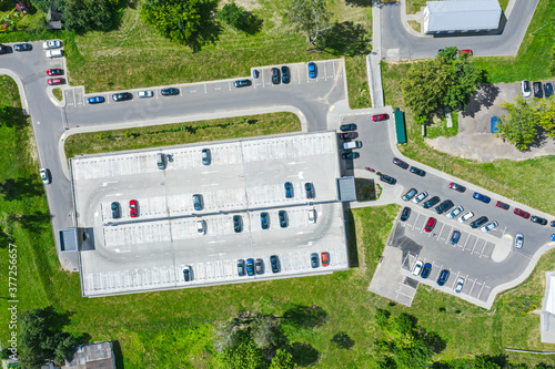 parking lot with cars and multistorey car parking in residential area. aerial top view