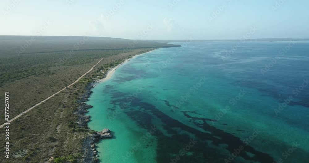 Impressive aerial shot with drone of the coasts of Cabo Rojo, Pedernales, on a clear morning overlooking the turquoise blue water and the vegetation of the area. Impressive aerial shot with drone of the coasts of Cabo Rojo, Pedernales, on a clear morning overlooking the turquoise blue water and the vegetation of the area.