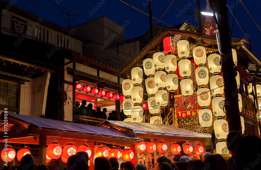 Naklejka premium Night view of Yamahoko float with lanterns and people listening to music in Gion Festival in Kyoto, Japan